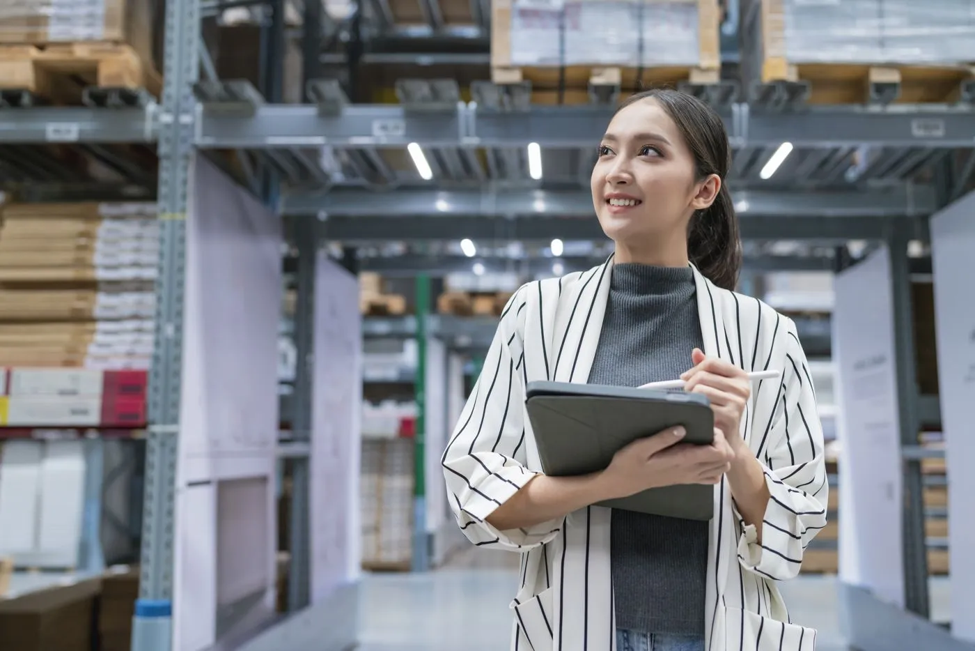 A team member using an ERP system on a tablet in a warehouse